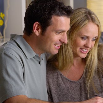 ein Mann und eine Frau sitzen am Laptop